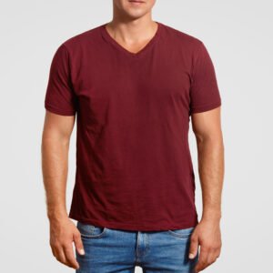 indoor cropped image of muscular young man in red t shirt and jeans, stands against white background, poses over white background, blank space or your logo or advertisement. clothing concept